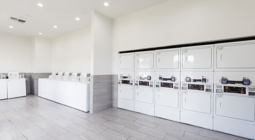 a laundry room with washers and dryers at The Lorenzo