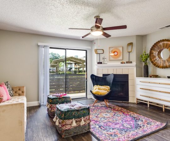 a living room with a fireplace and hardwood floors at The Lorenzo